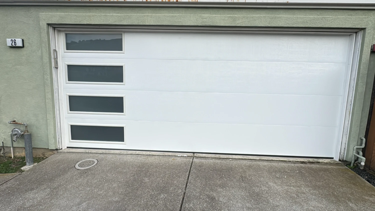 A white garage door with window panels