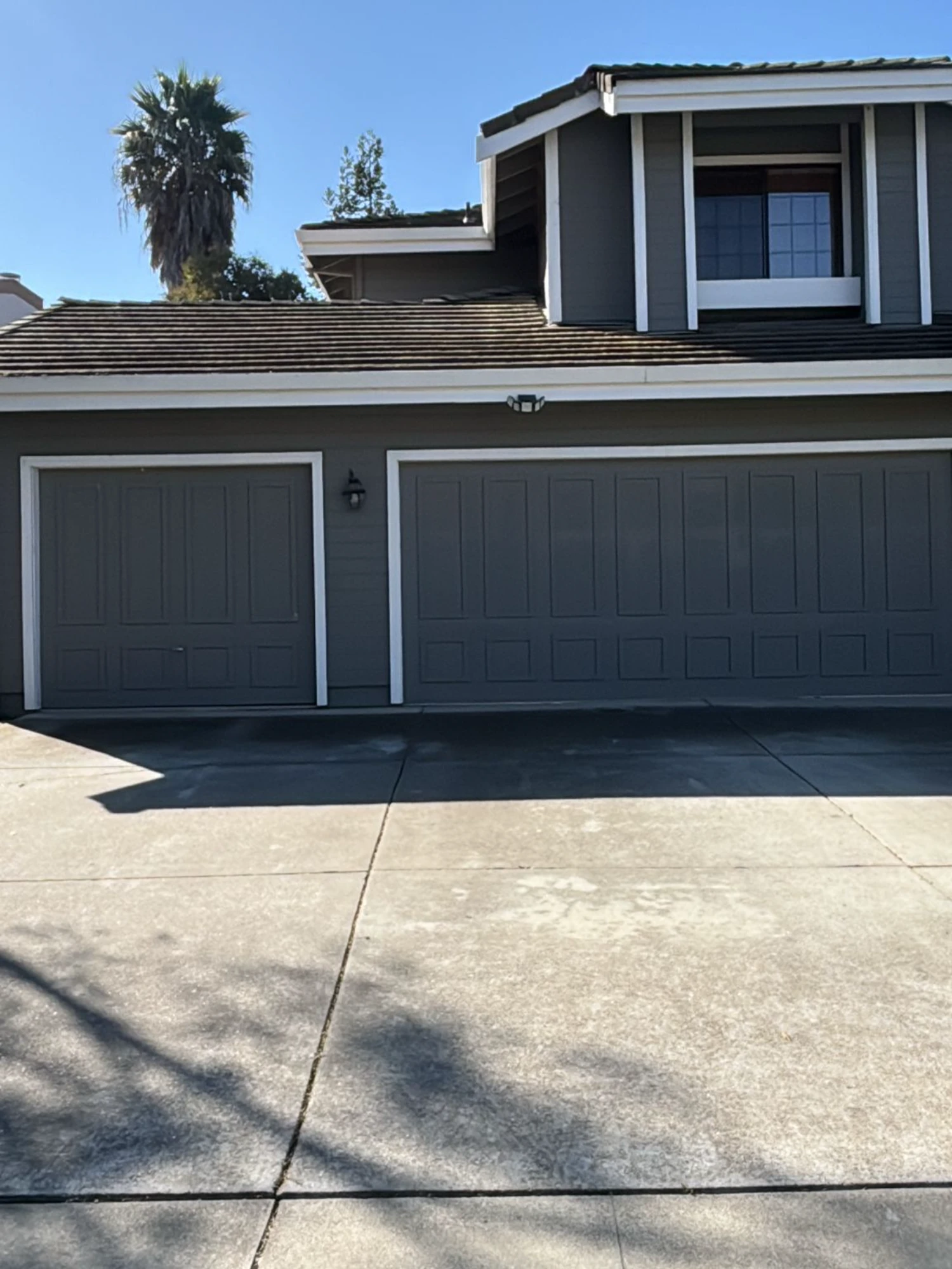 A brown house with a five-car garage