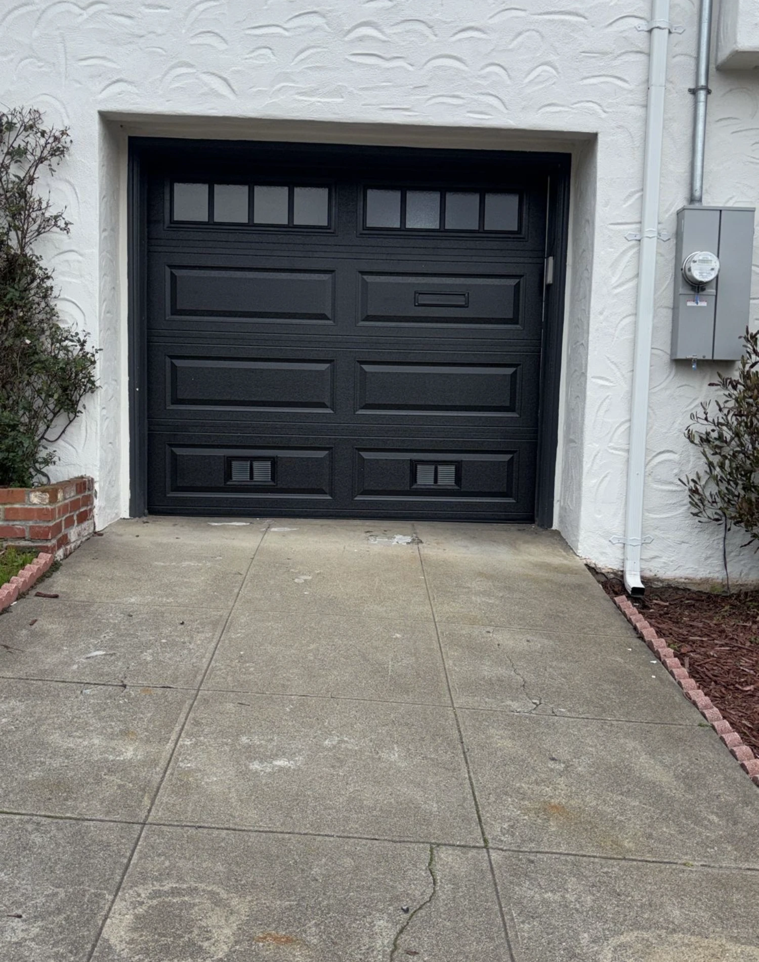 A home with a black paneled garage door