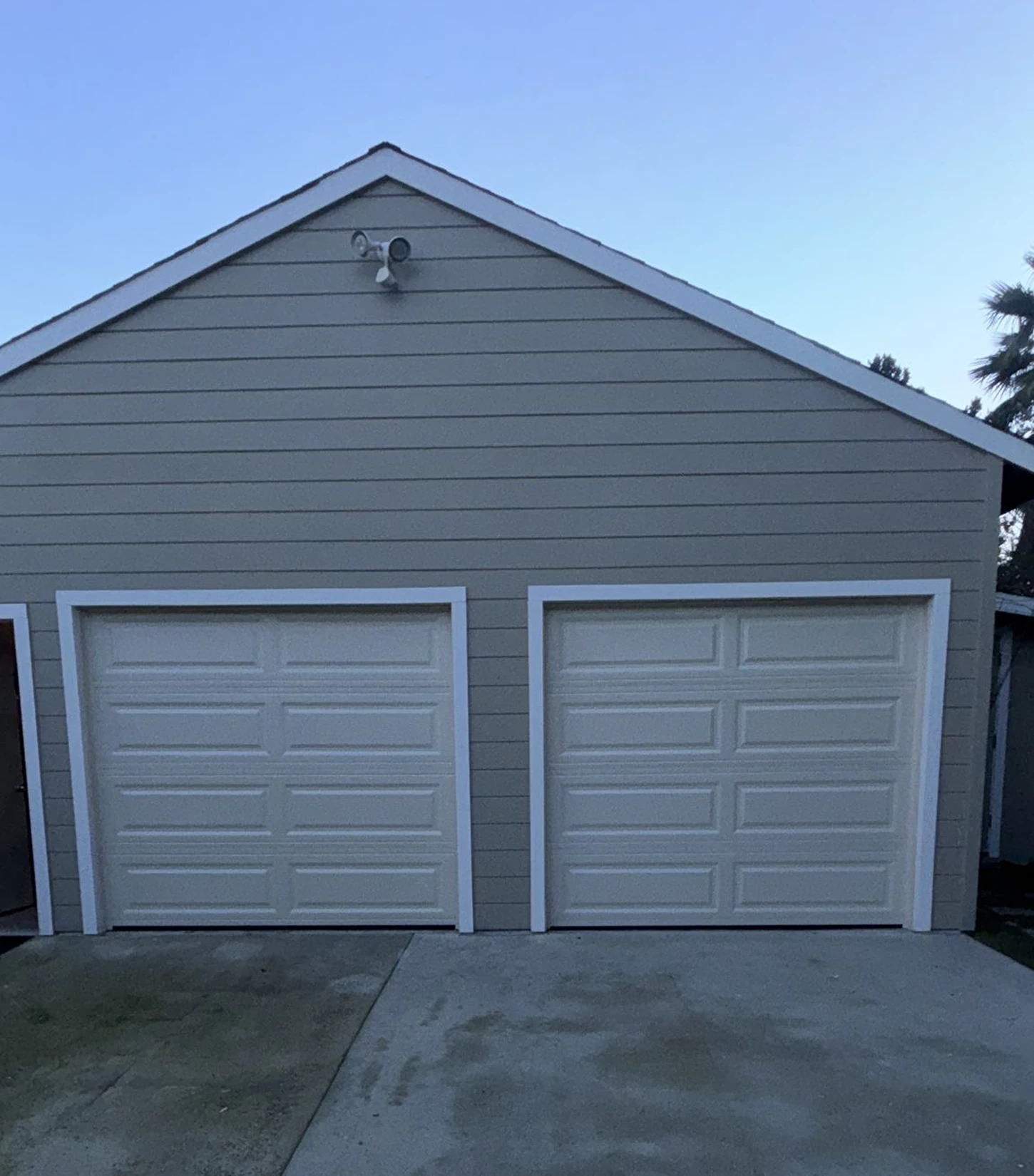 A home with two newly installed garage doors