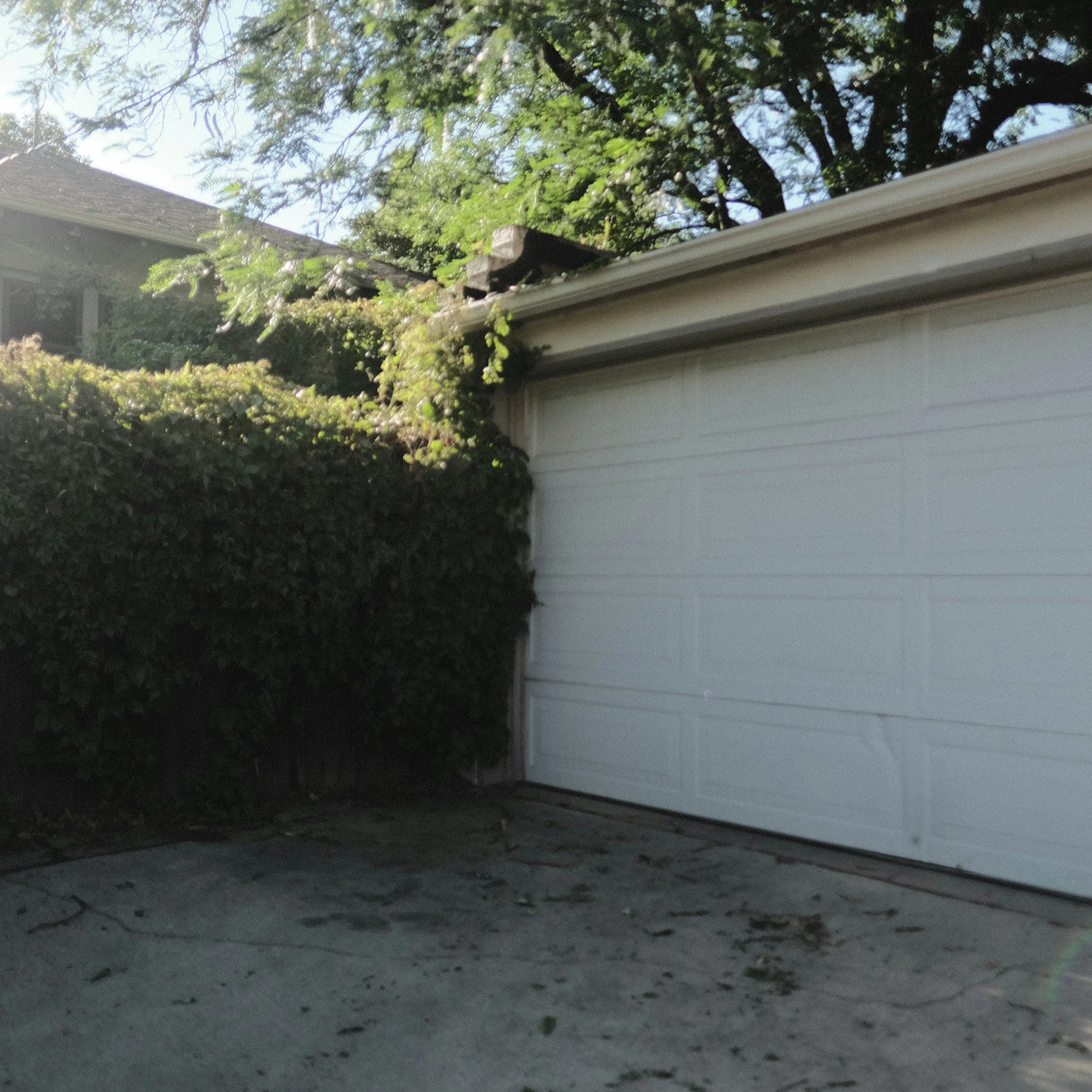 Residential garage door with a dent on the bottom panel