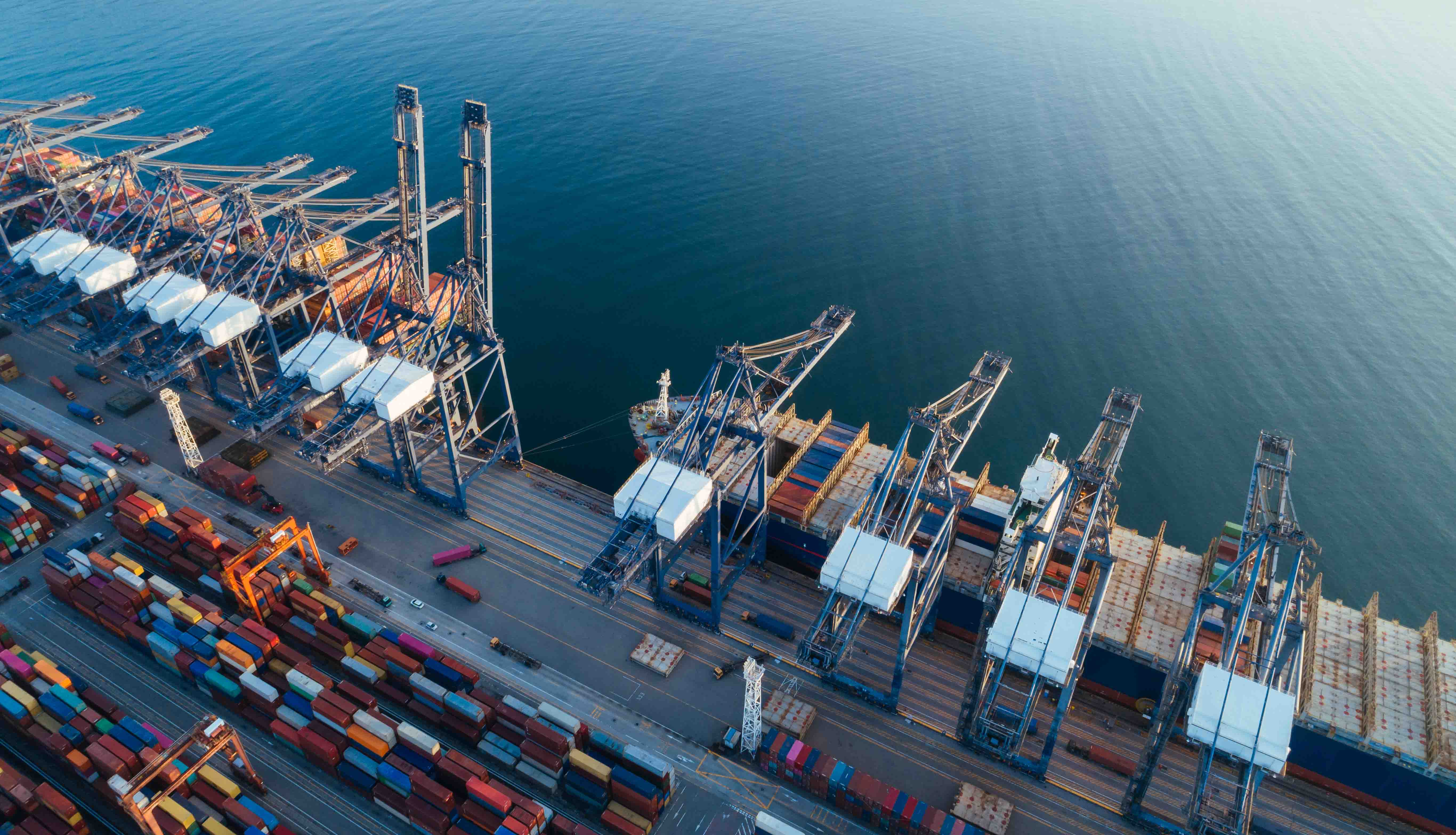 Aerial shot of shipping cranes moving containers