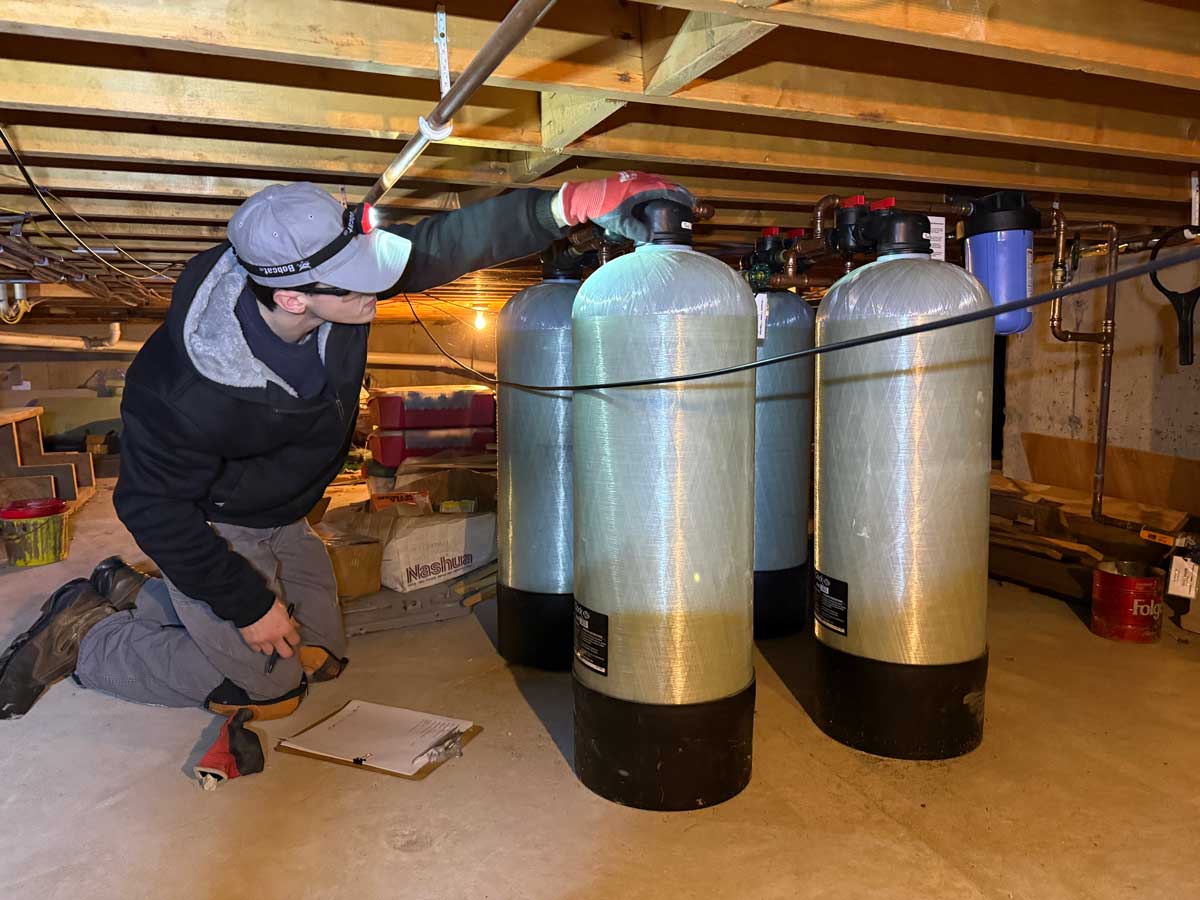 Placeholder photo — will be replaced with technician.png (technician installing water softener)