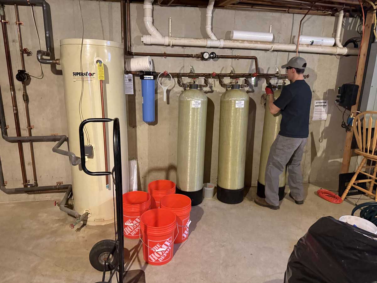 Whole-house iron and manganese filtration tanks installed by A & B Water Consultants in a New Hampshire basement