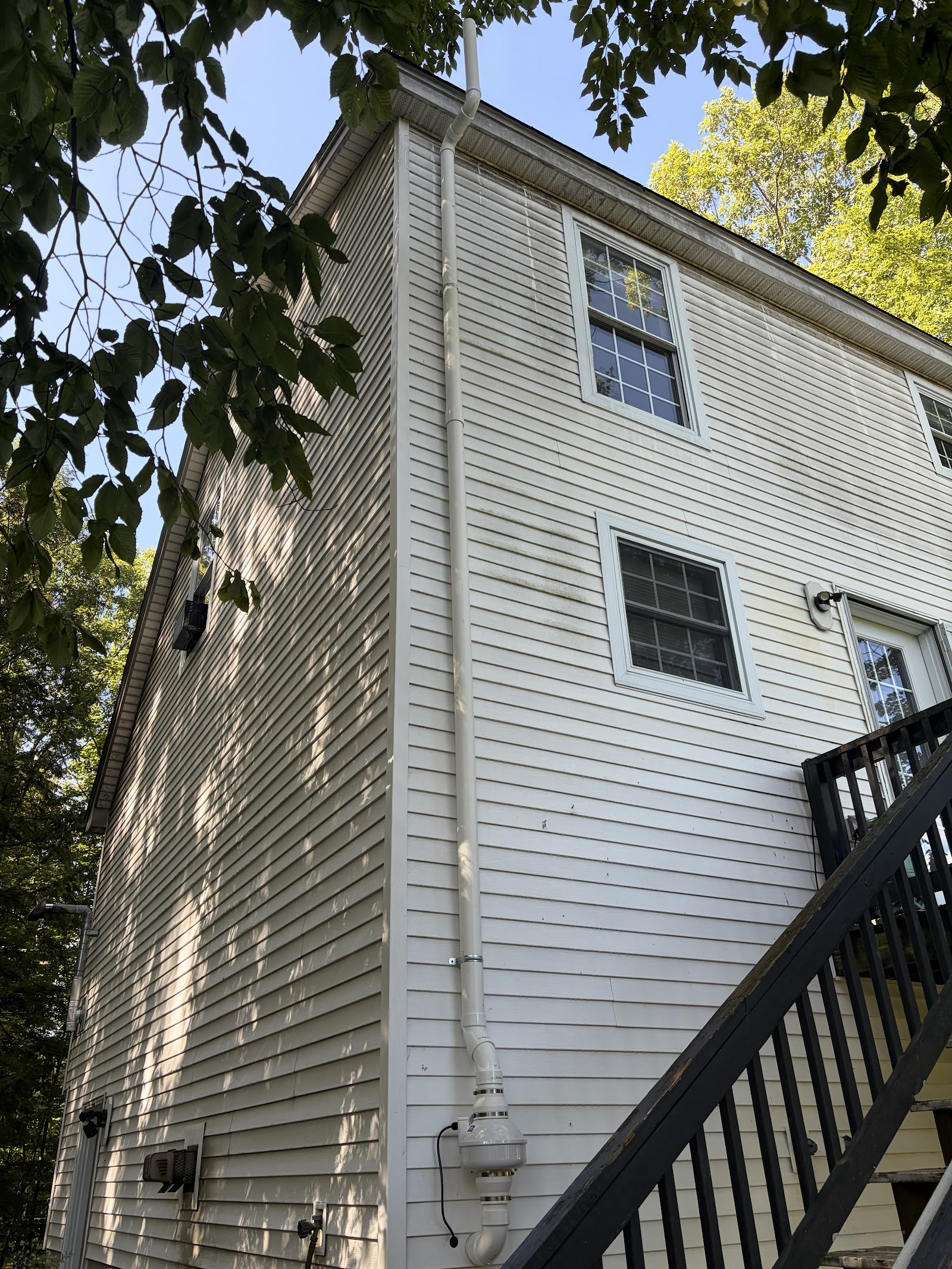 Exterior radon air mitigation system installed on a home in Canterbury, New Hampshire
