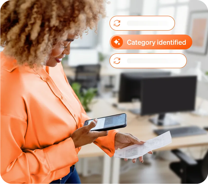 A smiling woman using BILL.com in a professional office setting