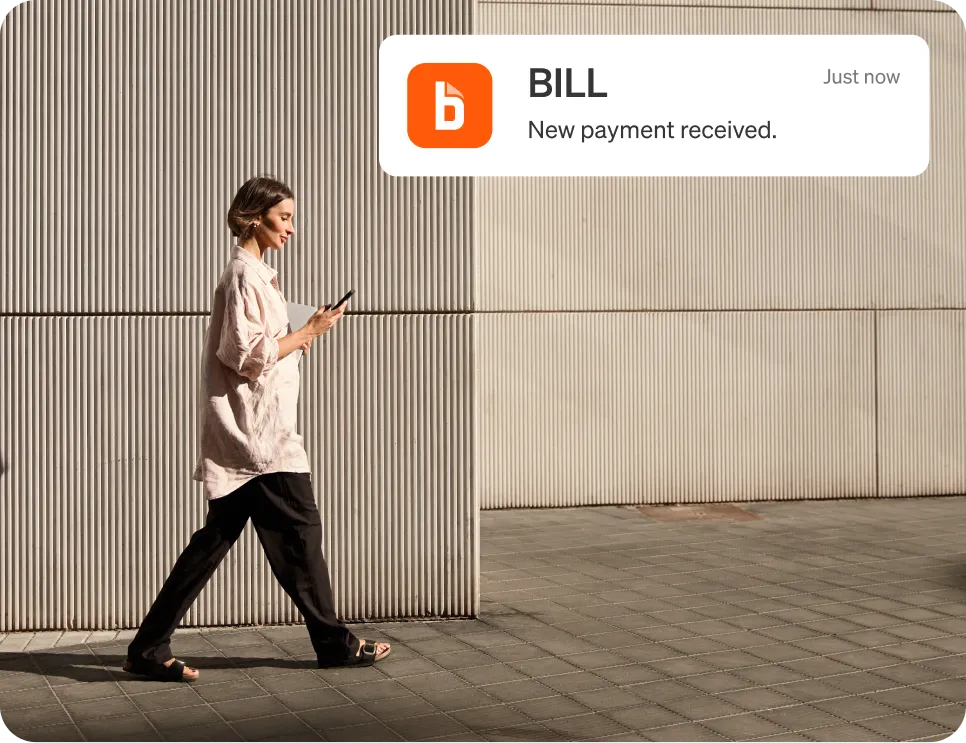 Woman walking and using BILL mobile app