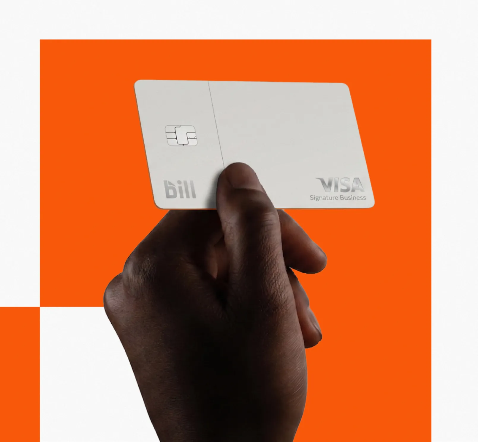 A hand holding a grey BILL Divvy Card in front of a graphic orange and white background.