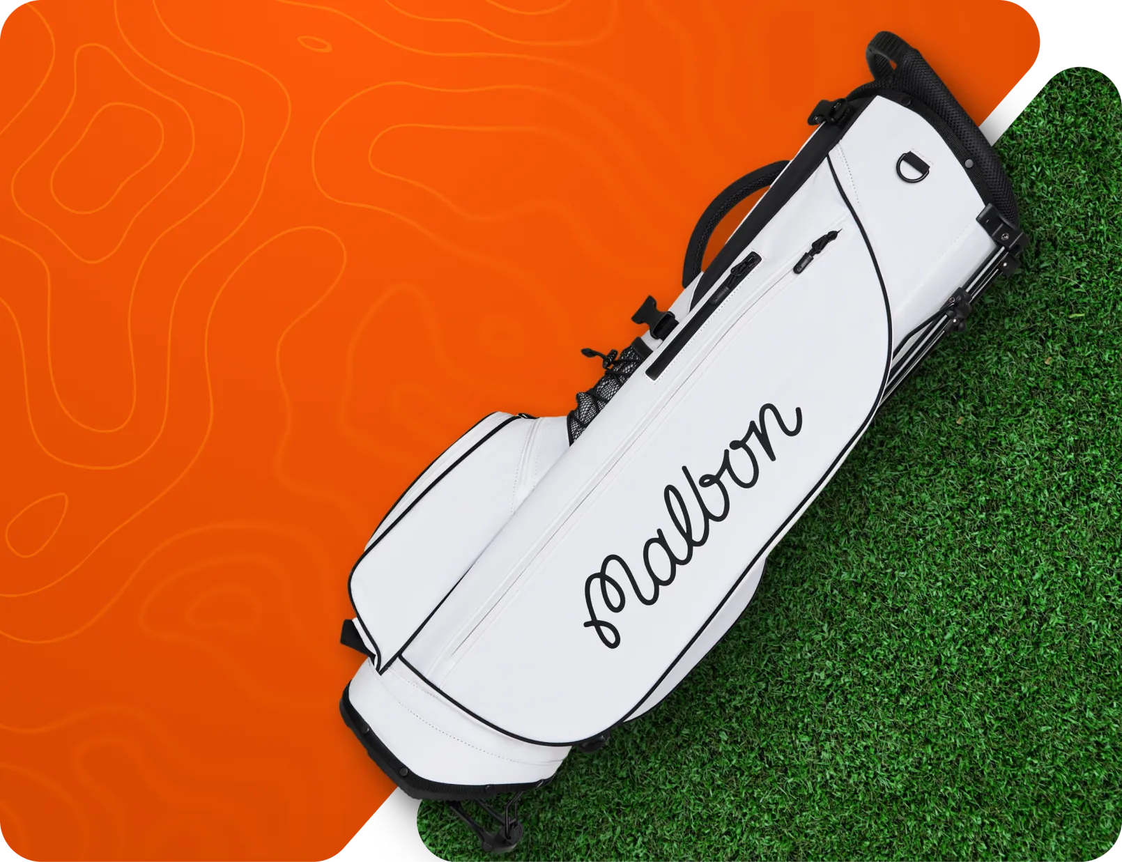White Malbon golf bag on a split orange and grass background.