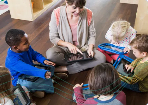 photo of teacher with students on tablets
