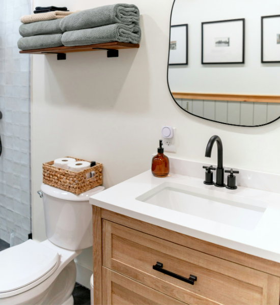 White quartz countertop remnant used for a bathroom vanity with wood cabinetry