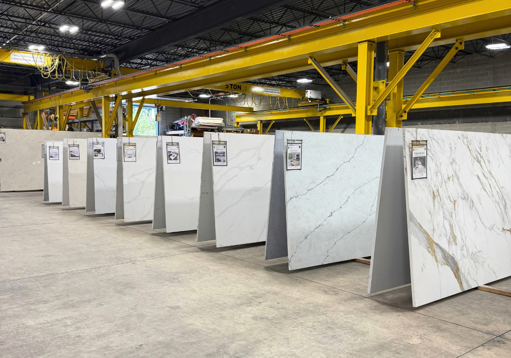 Full-size natural stone slabs displayed at Design Surfaces in Westlake, Ohio, featuring marble and quartzite selections for countertops.