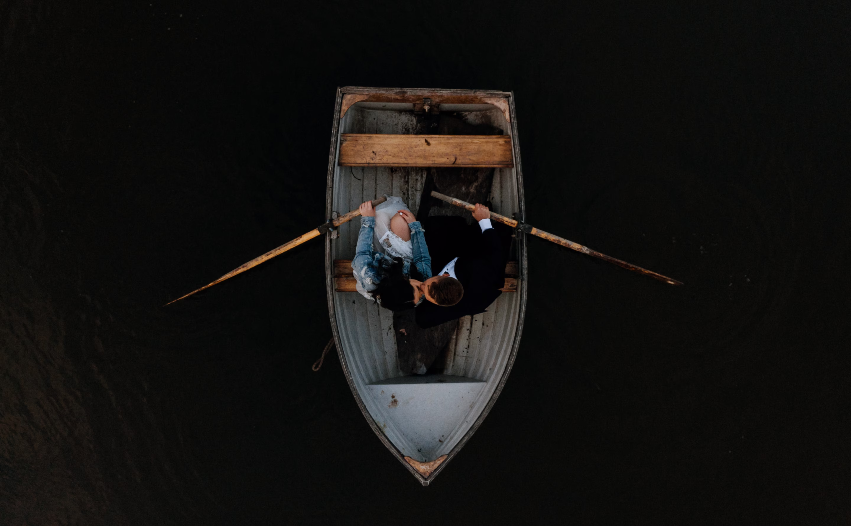 An above shot of a couple sitting in a small boat