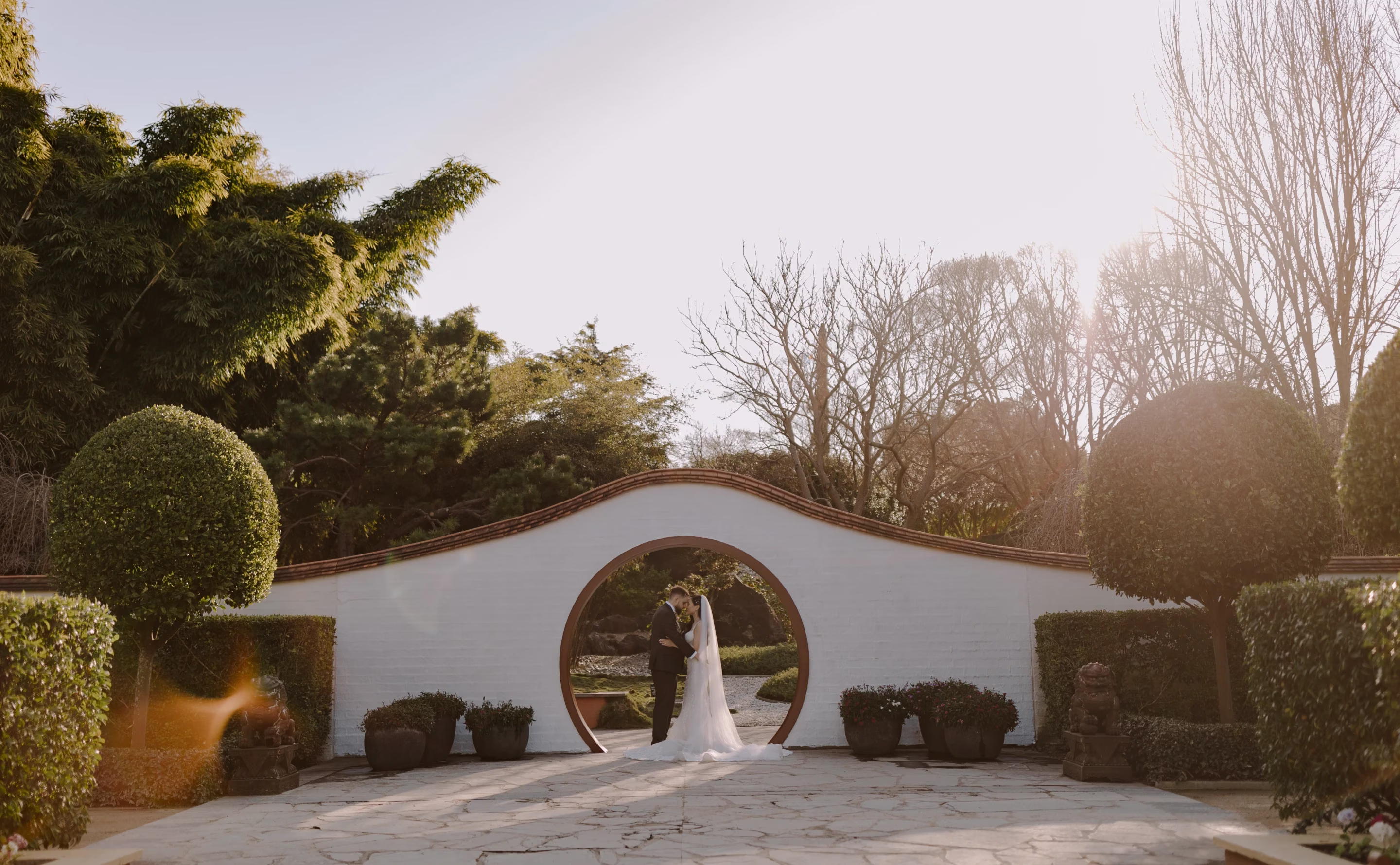 A couple standing in a beautiful garden