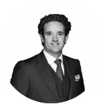 Black and white portrait of a man in a suit and tie looking at the camera.