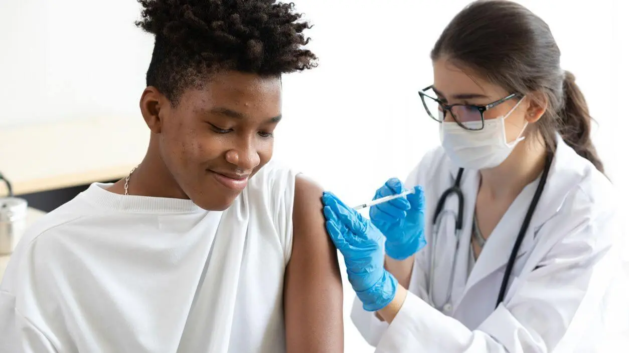 Adult getting a shot from a doctor