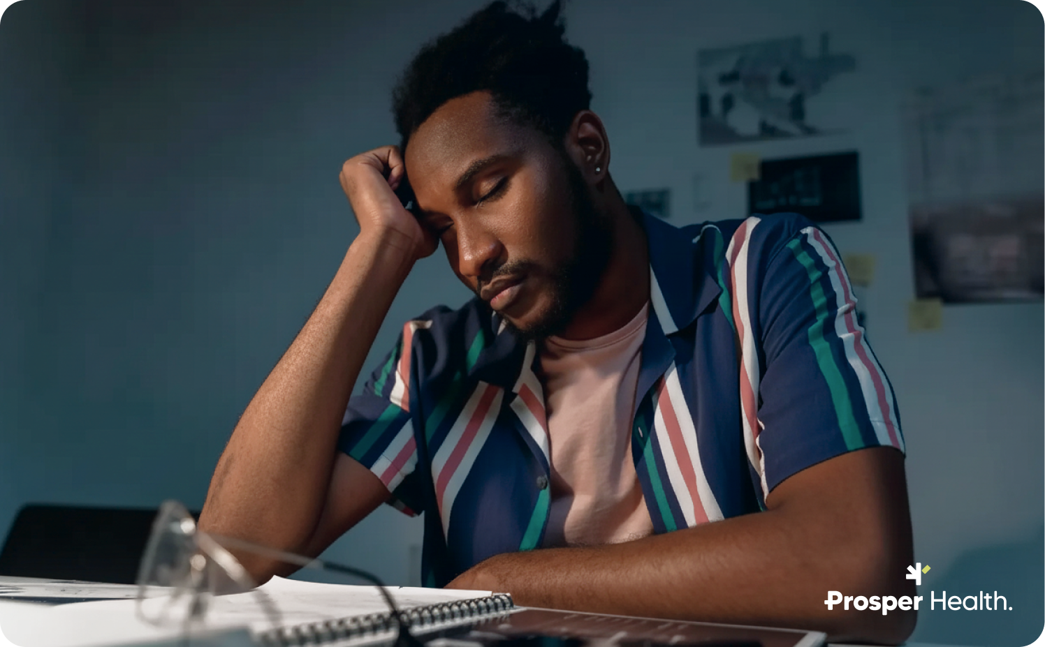 Autistic man supporting his head with his hand appearing exhausted