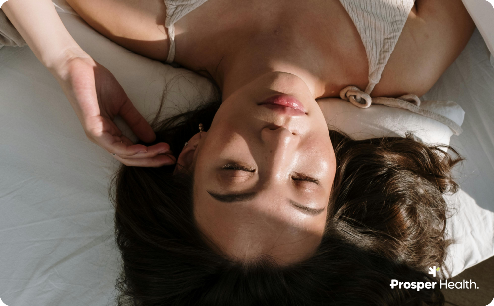 Close up of woman lying on the bed with eyes closed