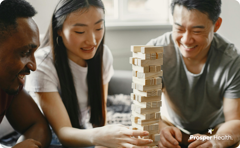 three friends playing jenga together