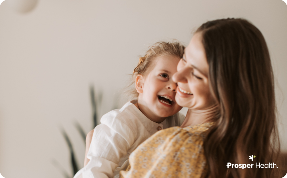 Autistic mother with daughter hugging and laughing