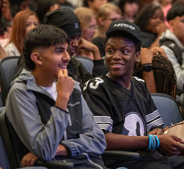 Happy smiling people looking at a phone together