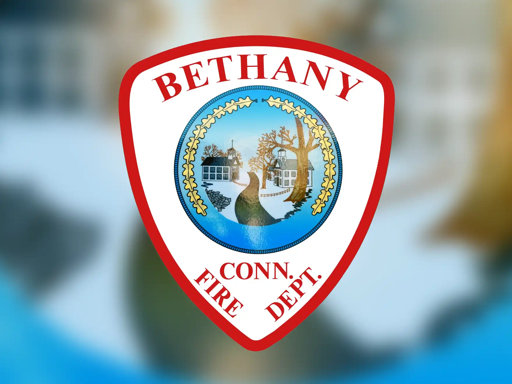 Bethany Connecticut Fire Department shield logo featuring red border, town seal with tree and buildings