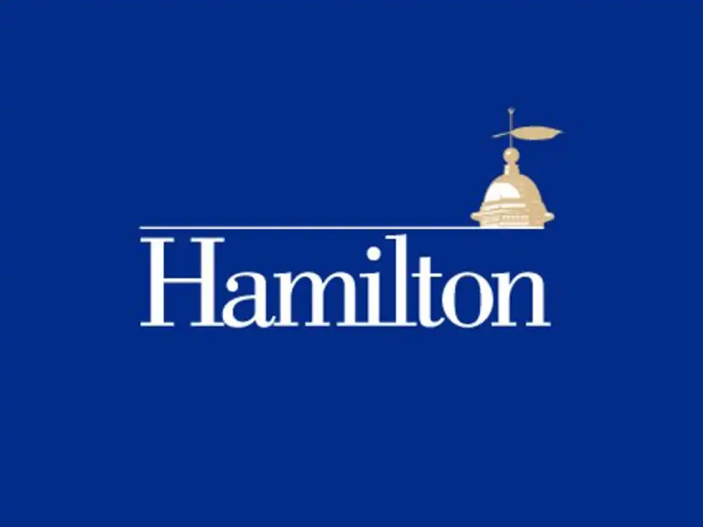Hamilton College logo on a blue background, featuring the word "Hamilton" in white with a gold cupola and weathervane above the letters.