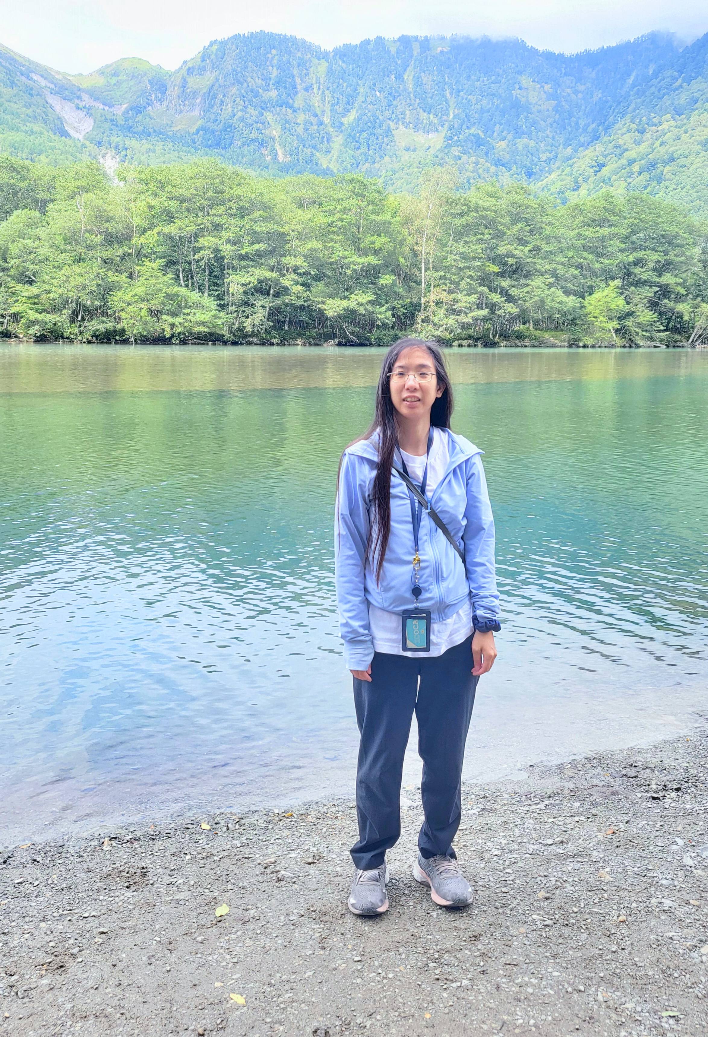 a picture of me standing in front of a pond in Kamikochi, Japan