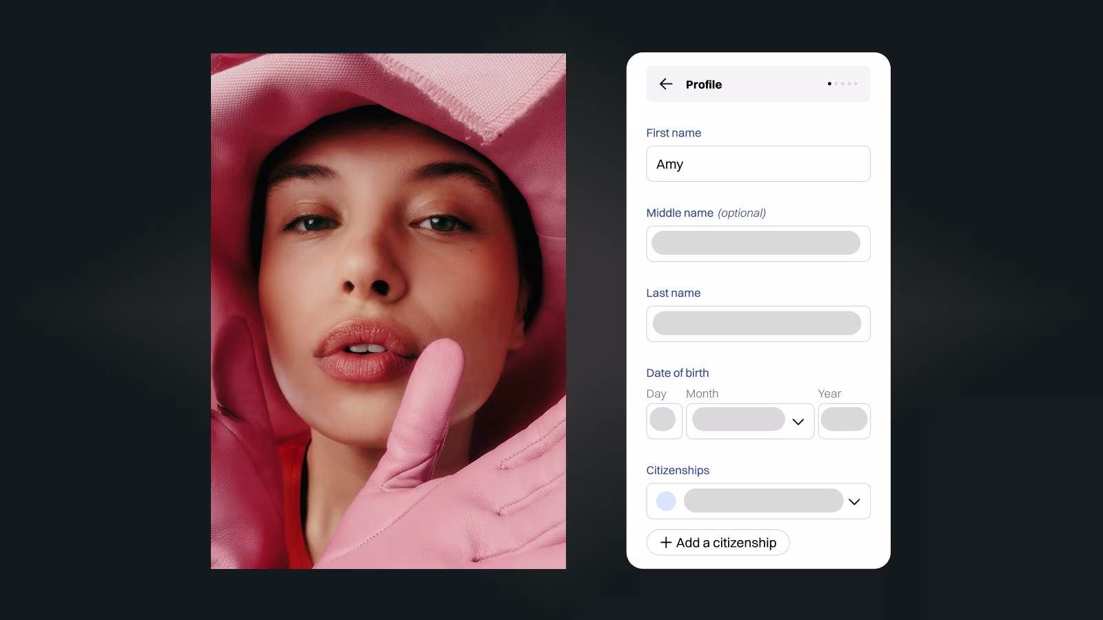 Mobile app profile screen showing fields for first name Amy, middle name, last name, date of birth, and citizenships next to a portrait of a woman wearing pink gloves and fabric framing her face.