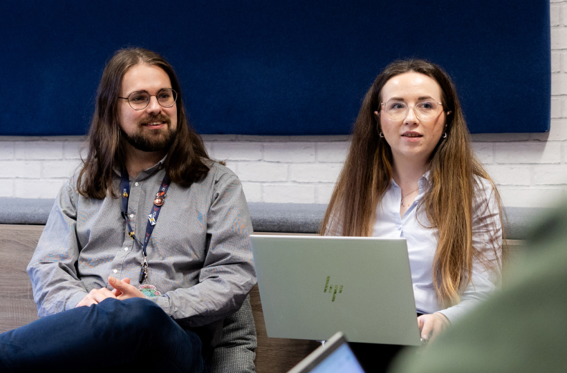 Two ICS-translate colleagues reviewing translated content on a laptop
