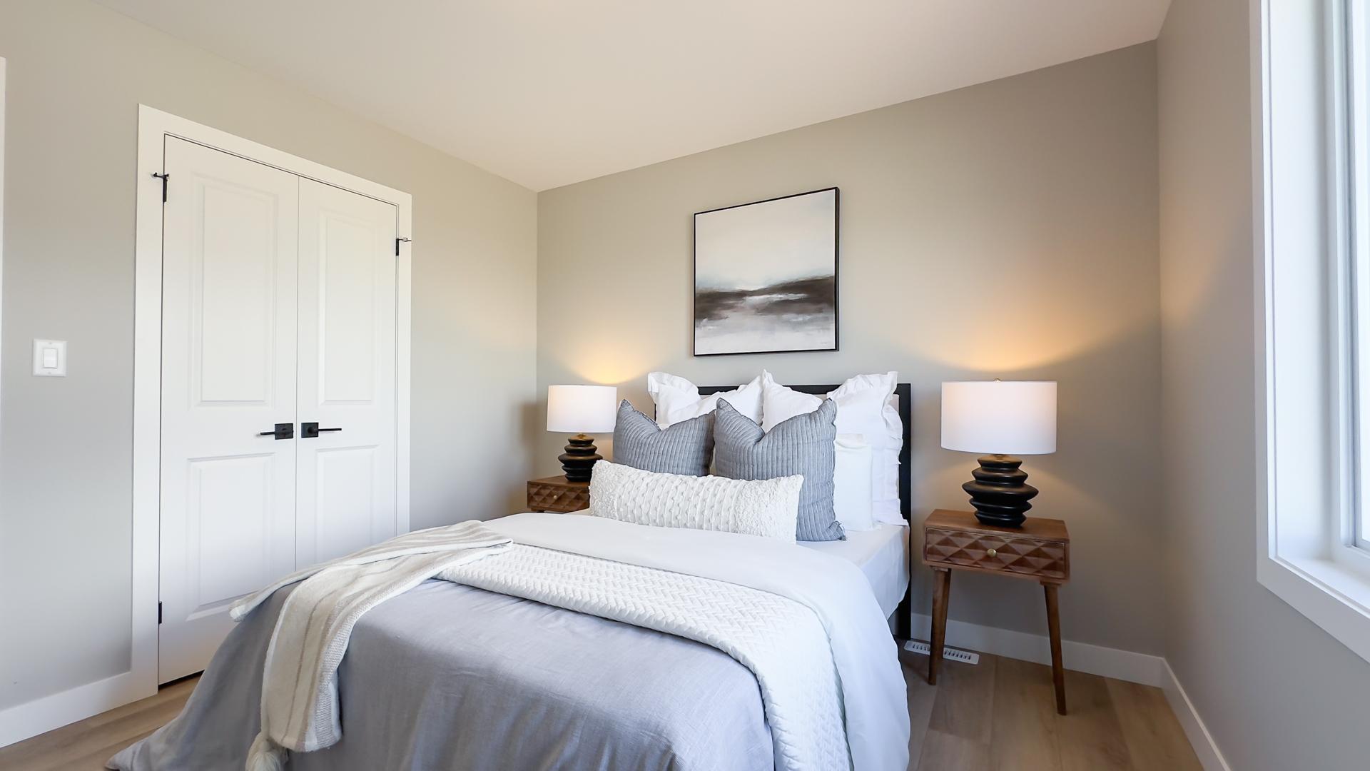 Secondary bedroom with large window and modern finishes