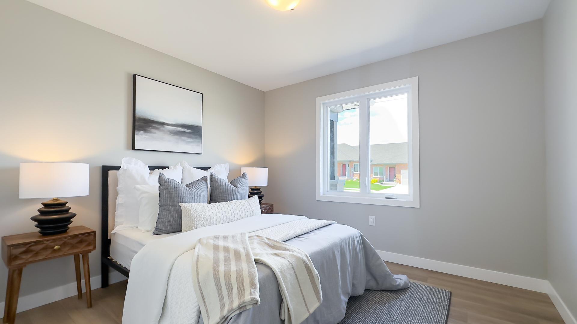 Secondary bedroom with large window and modern finishes
