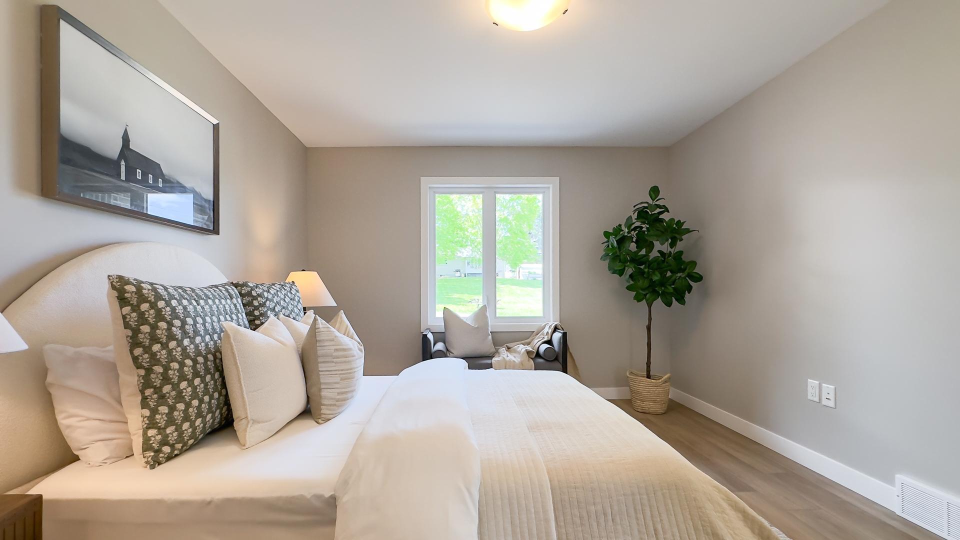 Primary bedroom with large windows, walk through closet and ensuite 