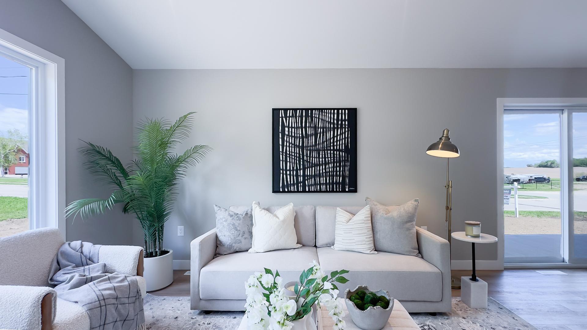 Open concept living room with large windows and vaulted ceilings