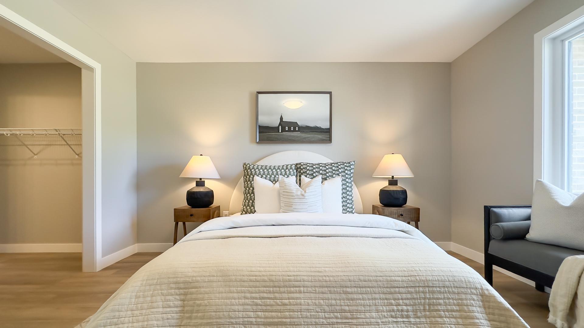 Primary bedroom with large windows, walk through closet and ensuite 