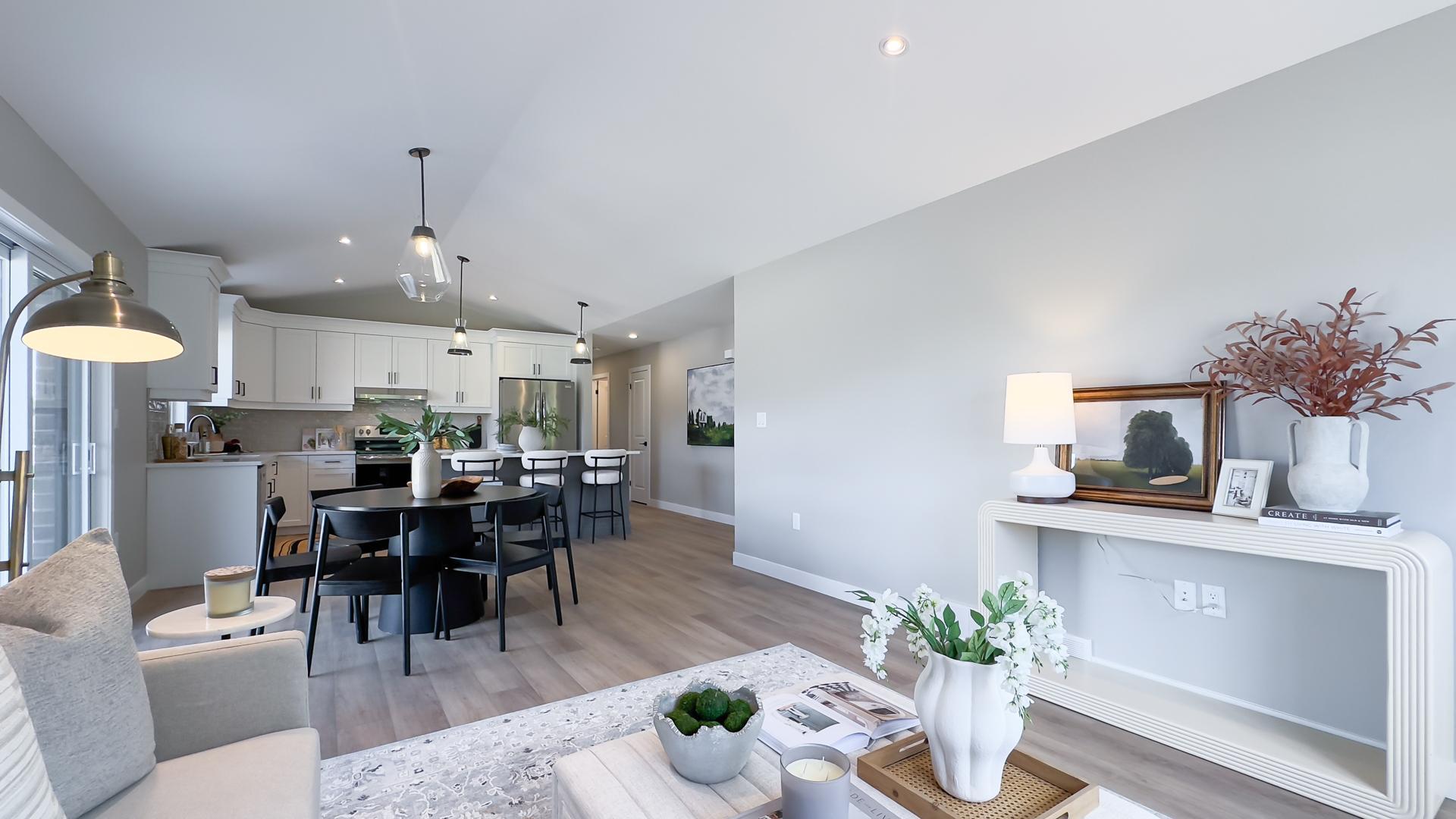 Open concept living room with large windows and vaulted ceilings