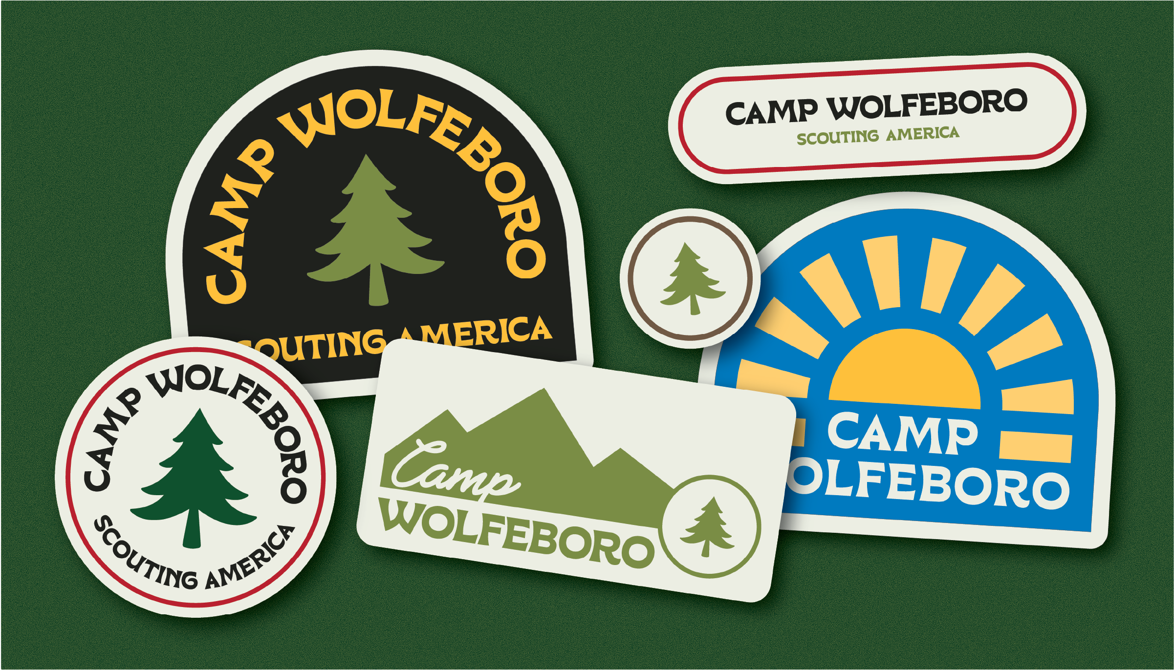 Collection of six Camp Wolfeboro patches featuring a pine tree, mountain, sun, and text 'Camp Wolfeboro Scouting America' on a green background.