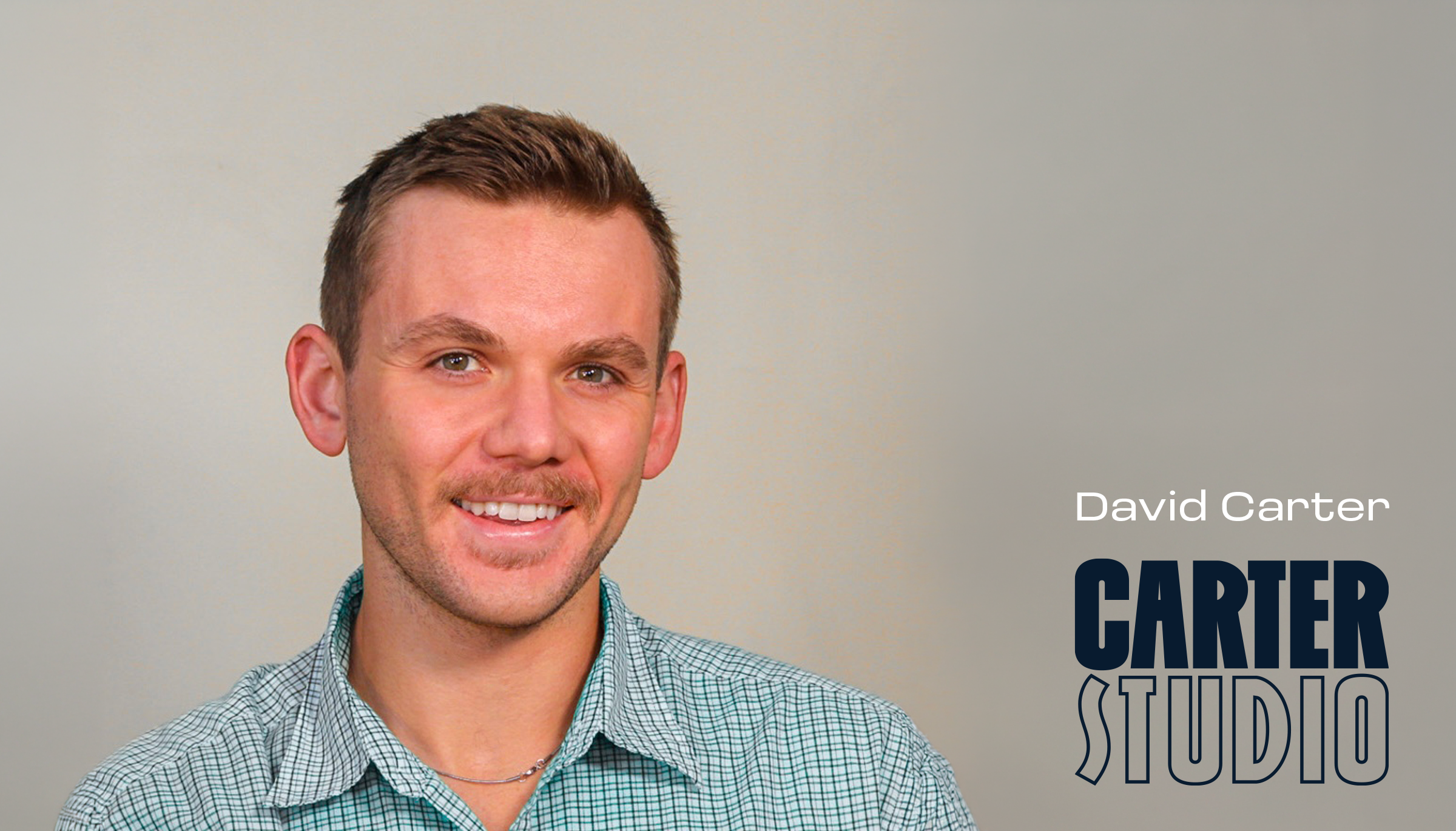 Smiling man with short brown hair, light mustache, wearing a green checkered shirt against a gray background with 'David Carter CARTER STUDIO' text.