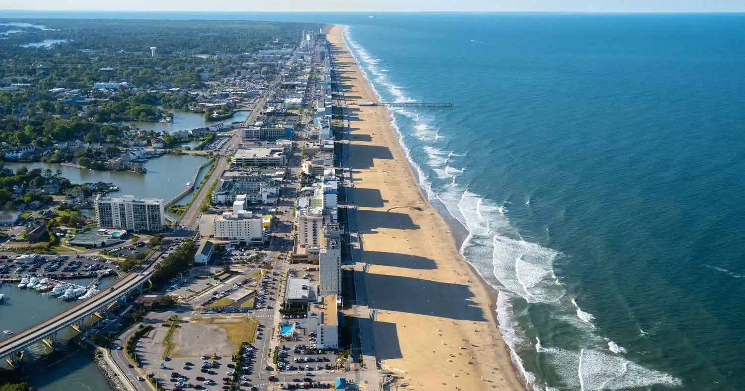 Aerial view of Virginia Beach coastline, sandy beach, and oceanfront hotels.
