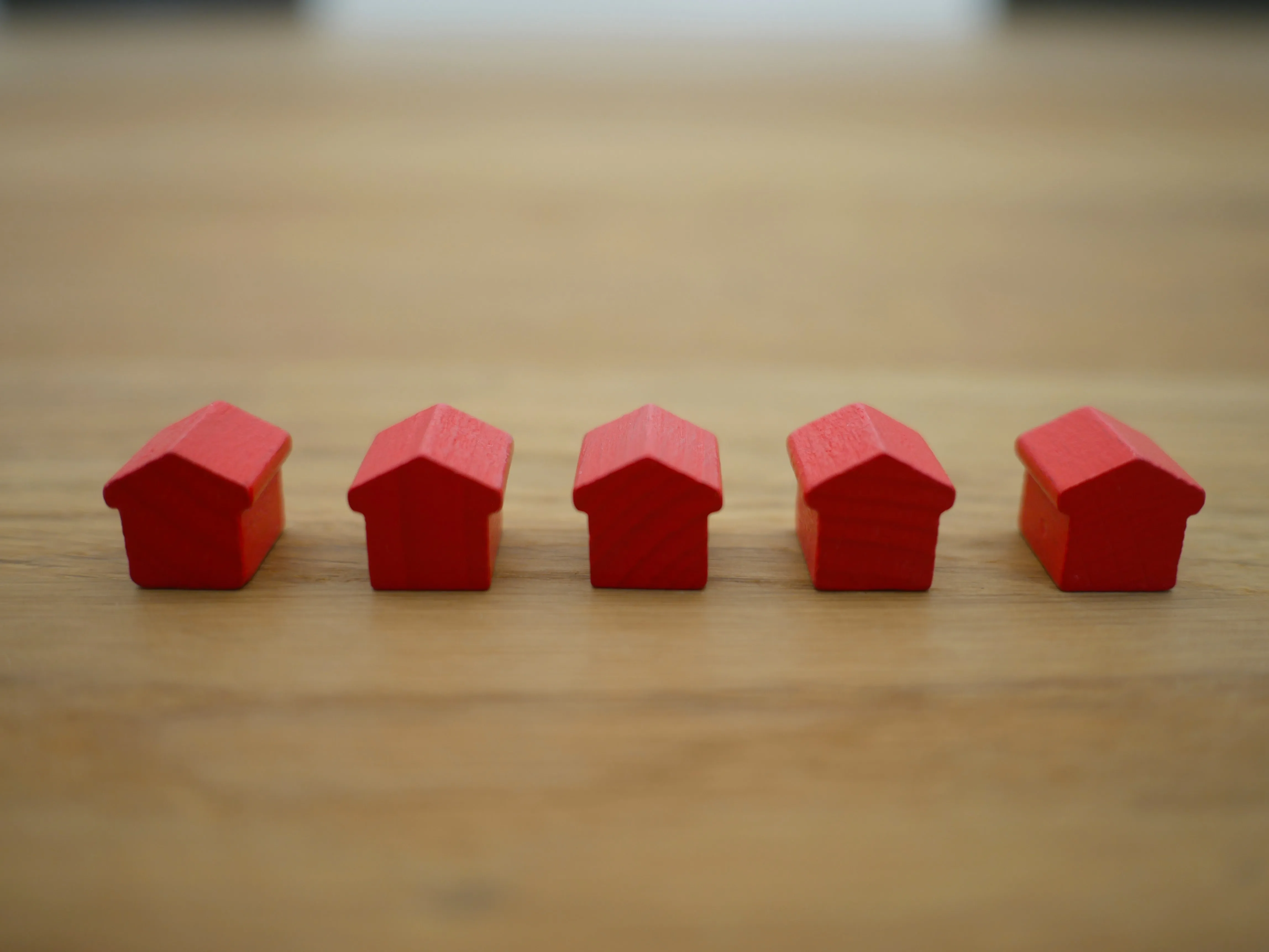 Small figures of wood houses on a desk