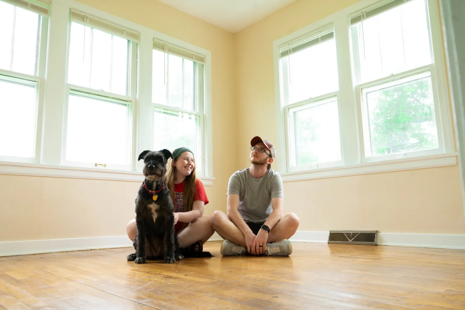 A picture of a couple with their dog on their new home