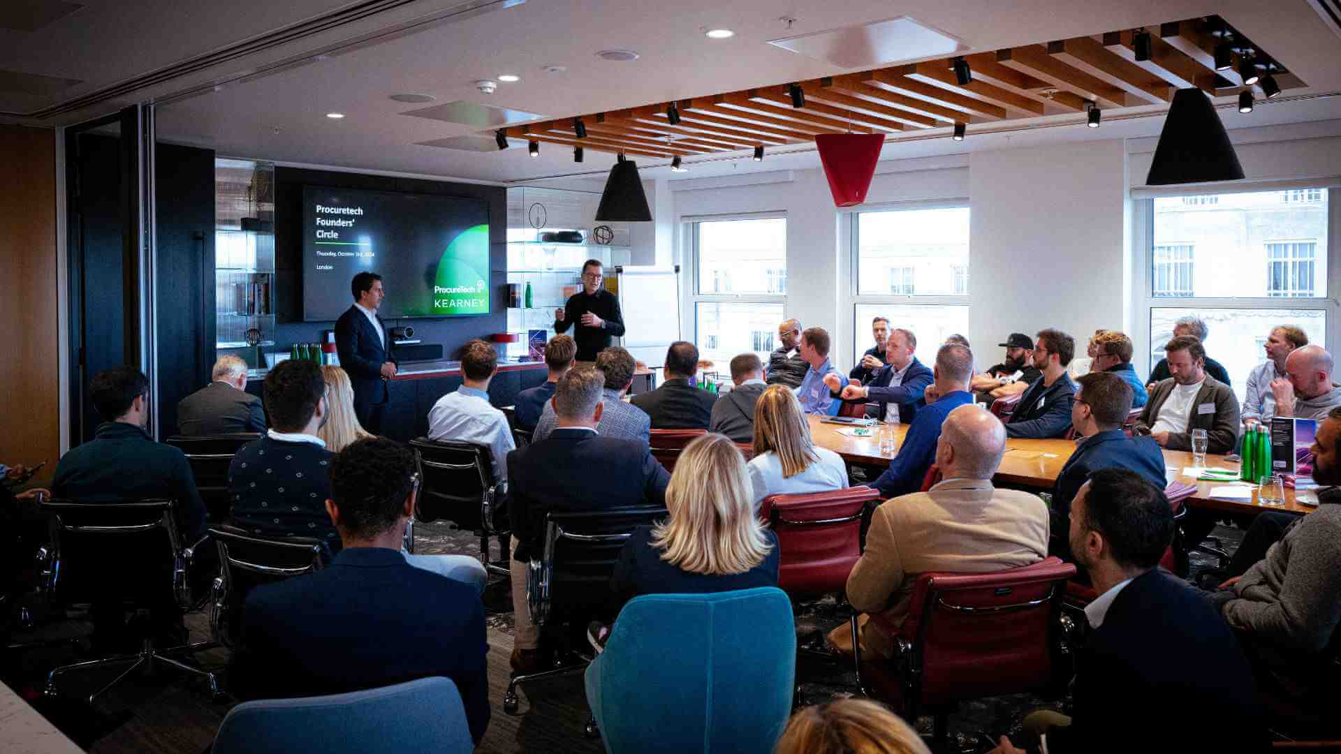 Participants of the ProcureTech Founders' Circle in London listening to the host.