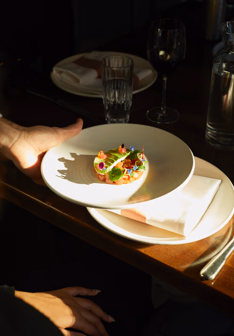 Private chef preparing a gourmet dish at an intimate dinner party in London