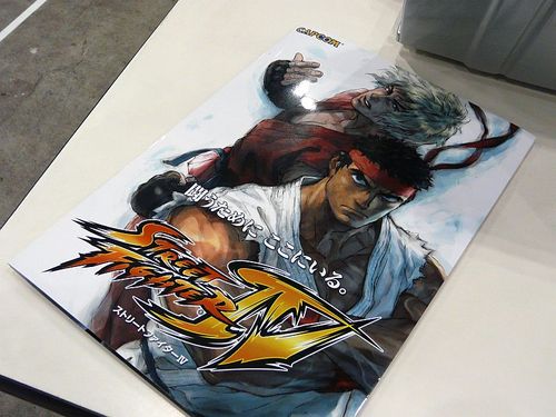 two rows of sit down candy games cabinets facing each other in a Japanese style arcade