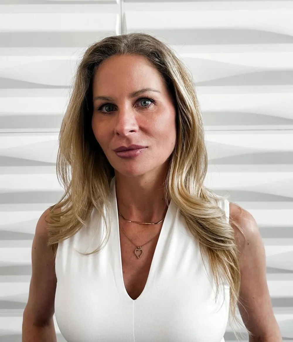 A profile picture of Lena James in front of a white wall with a raised wave pattern.