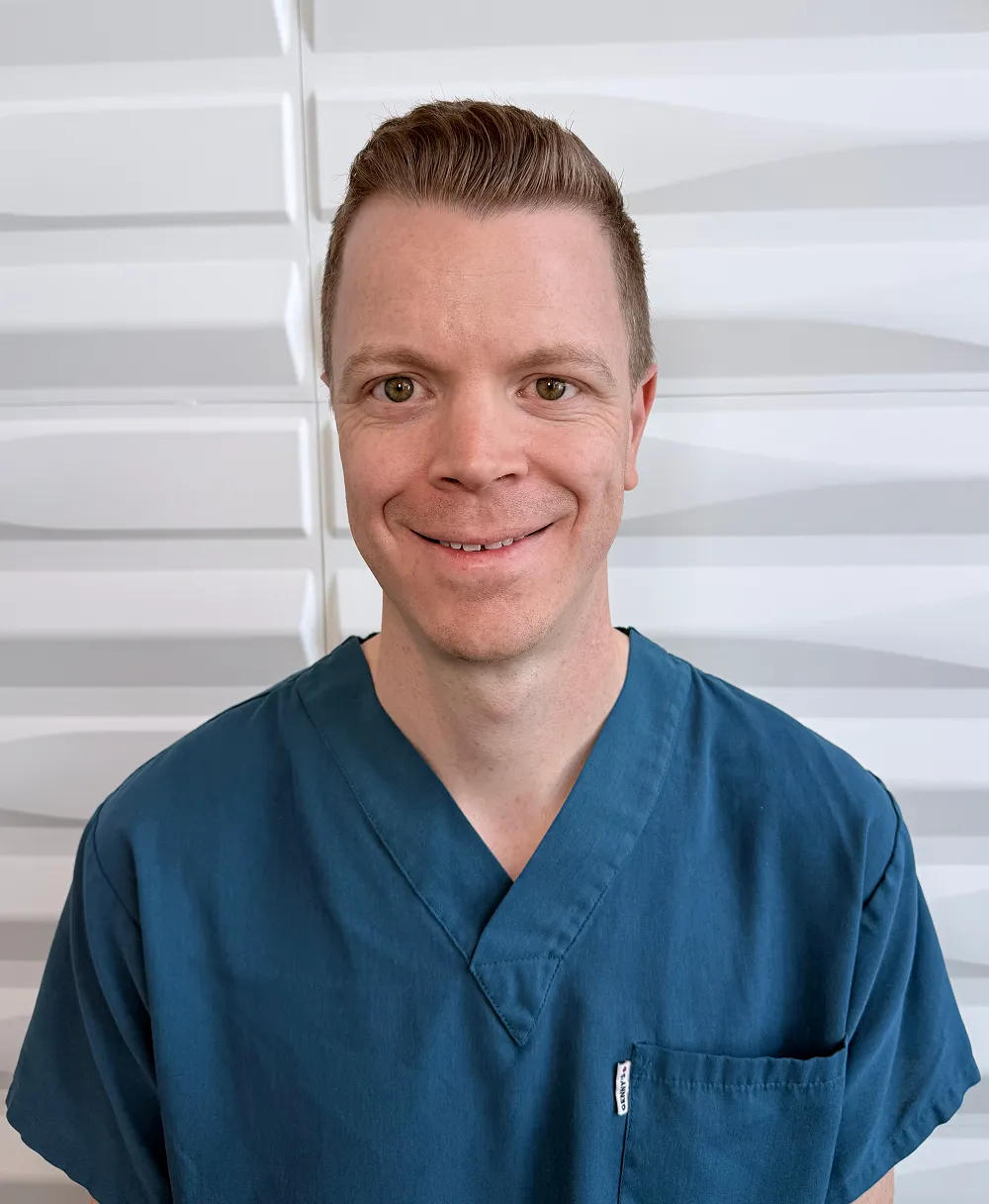 A profile picture of Matt Epp in front of a white wall with a raised wave pattern.