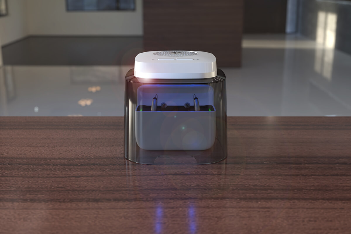 Dry box for all rechargeable hearing aids dry-cap uv 2.2® above a hearing aid charging station on a table in a realistic environment
