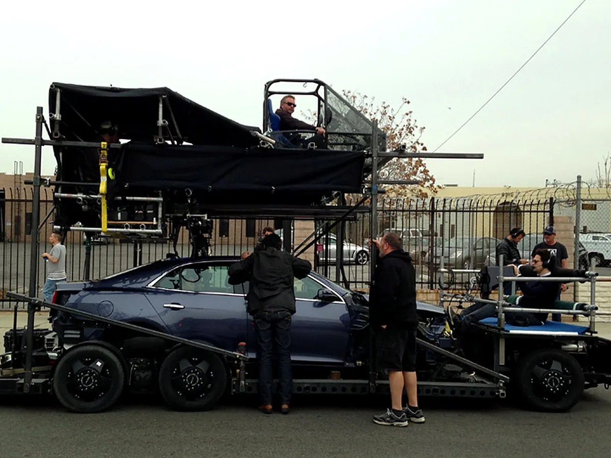 Two Axis Dolly rigged over a Chevy Malibu on a camera car