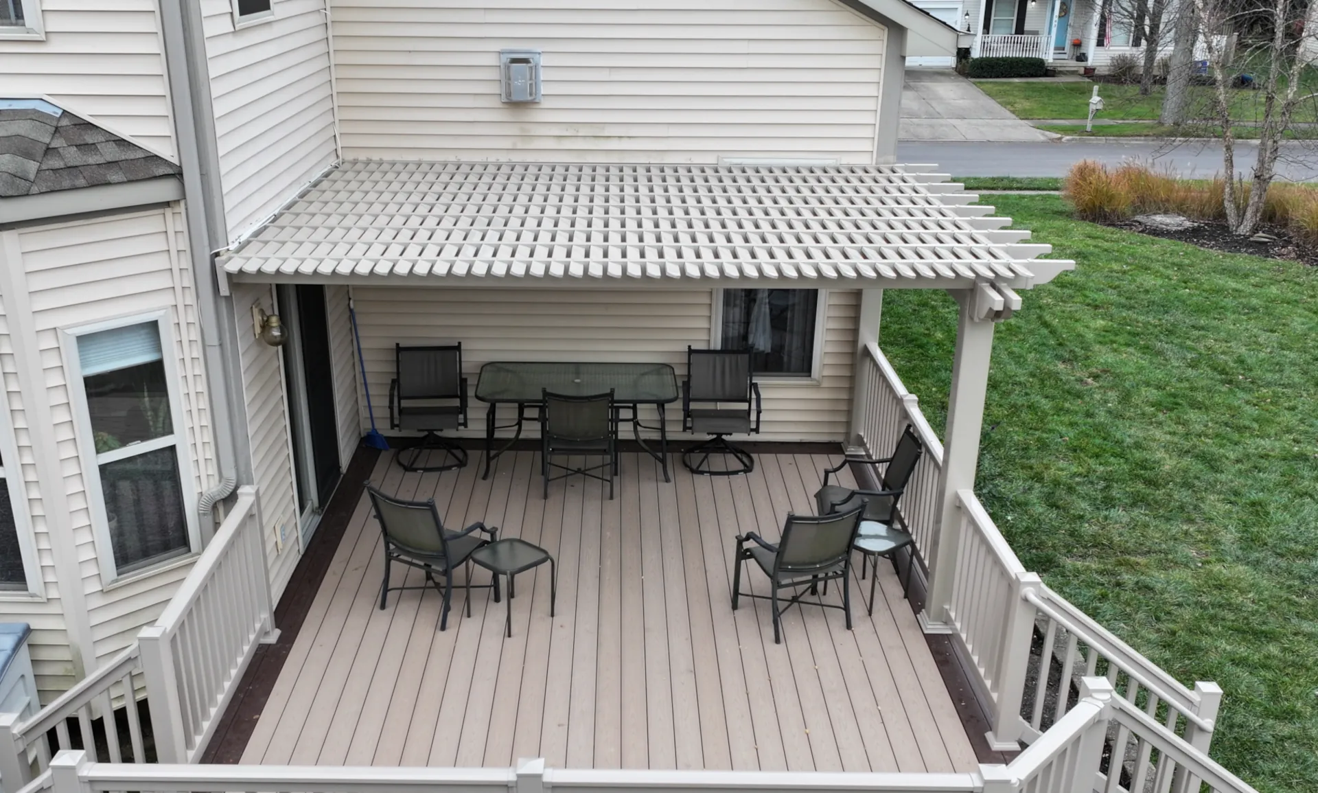 white pergola mounted on an existing deck