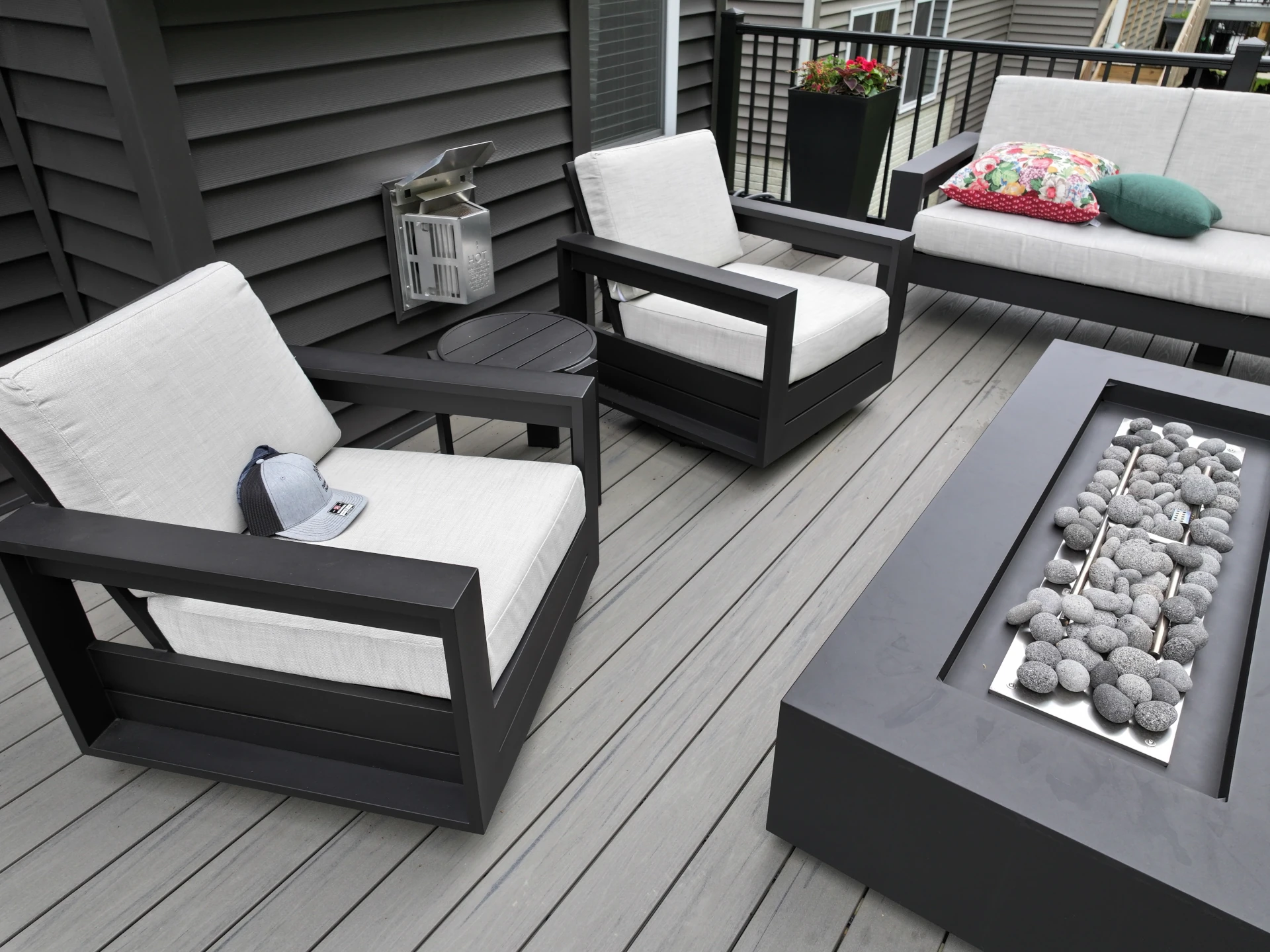 Close-up of Silver Maple composite decking with modern outdoor seating and a fire table in Westerville, Ohio.